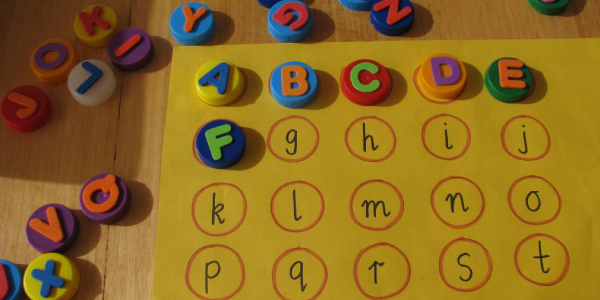 A Table Full Of Alphabetical Blocks Fixed To Their Respective Letters.