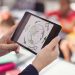 A Teacher Holding Tablet And Teaches The Kids.