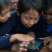 Group Of Students Operating The Tablet.