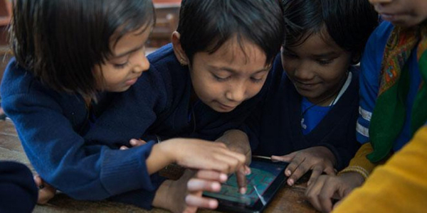 Group Of Students Operating The Tablet.