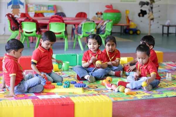 Preschooled Kids Doing Alphabet Activities On The floor.