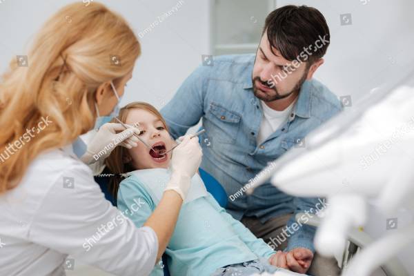 Cherishing father taking her little girl to a specialist